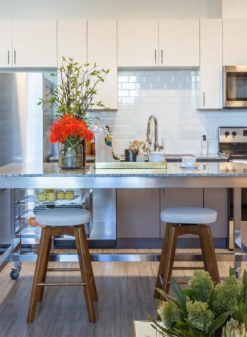 View of desk, bed, and TV in private student bedroom at UC